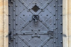 Close-up of metal door and knocker.
